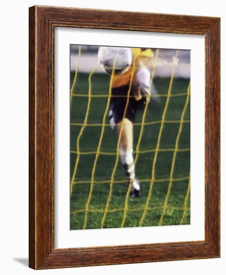 Soccer Player Kicking a Soccer Ball-null-Framed Photographic Print