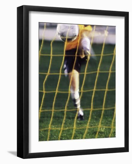 Soccer Player Kicking a Soccer Ball-null-Framed Photographic Print