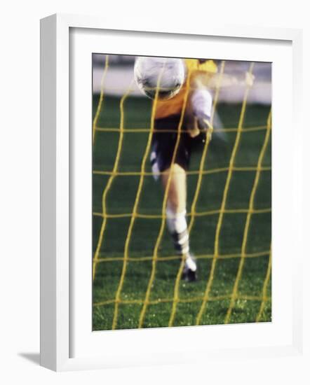 Soccer Player Kicking a Soccer Ball-null-Framed Photographic Print
