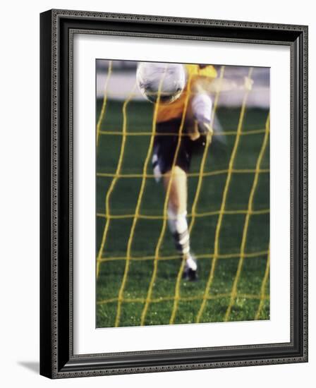 Soccer Player Kicking a Soccer Ball-null-Framed Photographic Print