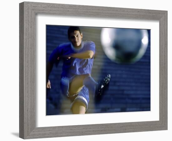 Soccer Player Kicking a Soccer Ball-null-Framed Photographic Print