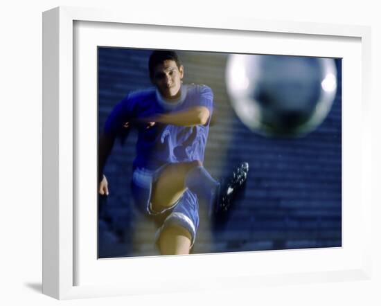 Soccer Player Kicking a Soccer Ball-null-Framed Photographic Print