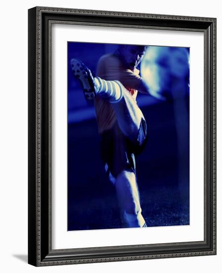 Soccer Player Kicking a Soccer Ball-null-Framed Photographic Print