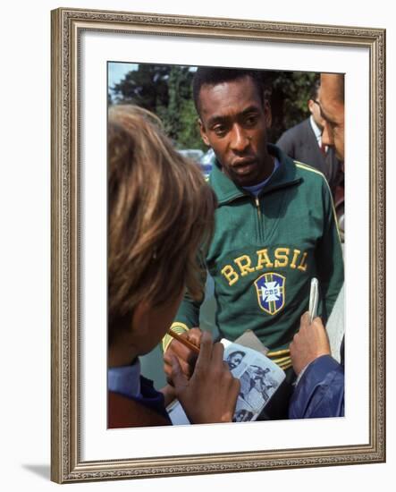 Soccer Star Pele Signing Autographs for Fans During a Practice Prior to World Cup Competition-null-Framed Premium Photographic Print