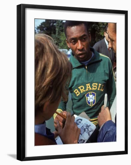 Soccer Star Pele Signing Autographs for Fans During a Practice Prior to World Cup Competition-null-Framed Premium Photographic Print