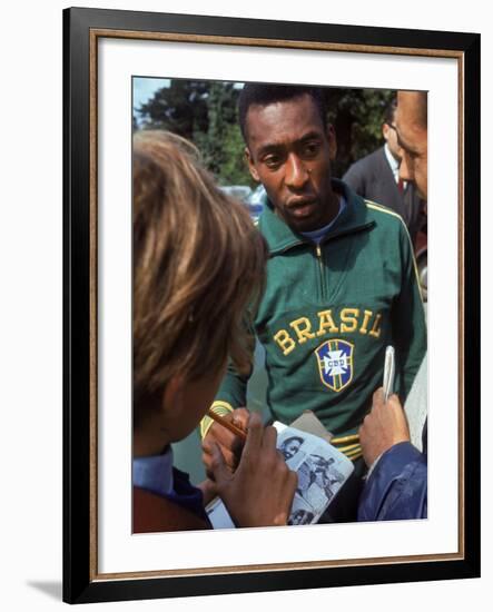 Soccer Star Pele Signing Autographs for Fans During a Practice Prior to World Cup Competition-null-Framed Premium Photographic Print