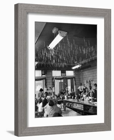 Soda Fountain Proprietor Watching as Kids Use Drinking Straw Covers as Straw Blowgun Missiles-Wallace Kirkland-Framed Photographic Print