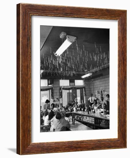 Soda Fountain Proprietor Watching as Kids Use Drinking Straw Covers as Straw Blowgun Missiles-Wallace Kirkland-Framed Photographic Print