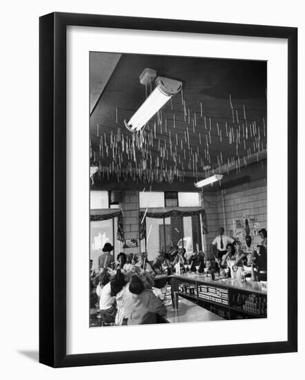 Soda Fountain Proprietor Watching as Kids Use Drinking Straw Covers as Straw Blowgun Missiles-Wallace Kirkland-Framed Photographic Print