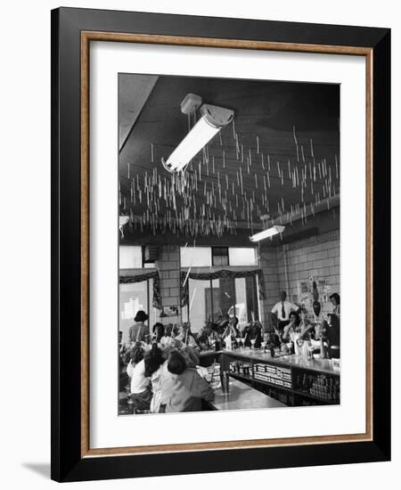 Soda Fountain Proprietor Watching as Kids Use Drinking Straw Covers as Straw Blowgun Missiles-Wallace Kirkland-Framed Photographic Print