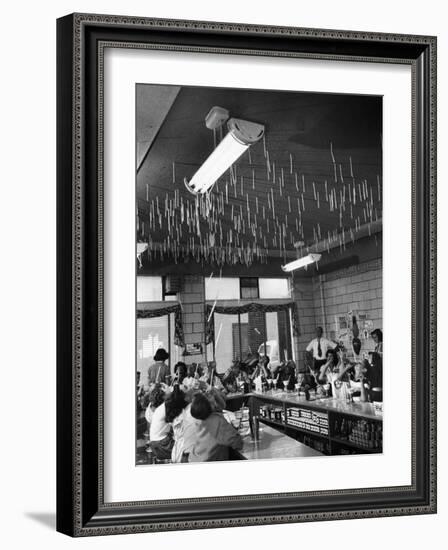 Soda Fountain Proprietor Watching as Kids Use Drinking Straw Covers as Straw Blowgun Missiles-Wallace Kirkland-Framed Photographic Print