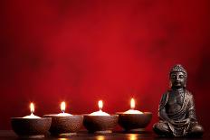 Buddha and Candles on Red Background, Religious Concept.-Sofiaworld-Photographic Print