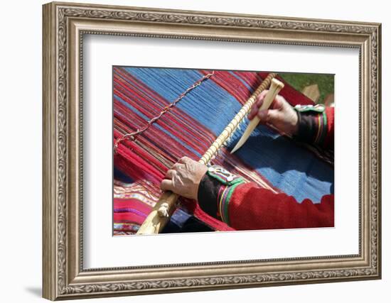 South America, Peru, Chinchero. Chinchero Cooperative weaver demonstrates using loom and tool.-Kymri Wilt-Framed Photographic Print