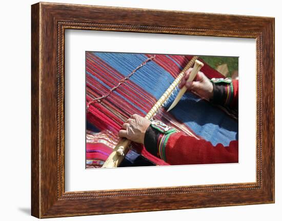 South America, Peru, Chinchero. Chinchero Cooperative weaver demonstrates using loom and tool.-Kymri Wilt-Framed Photographic Print