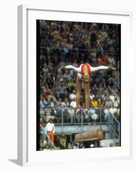 Soviet Gymnast Olga Korbut in Action on the Balance Beam at the Summer Olympics-John Dominis-Framed Premium Photographic Print