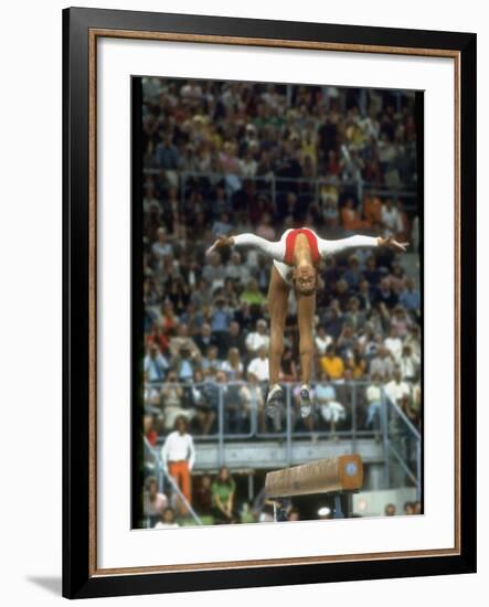 Soviet Gymnast Olga Korbut in Action on the Balance Beam at the Summer Olympics-John Dominis-Framed Premium Photographic Print