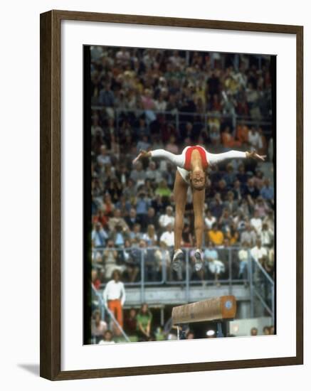 Soviet Gymnast Olga Korbut in Action on the Balance Beam at the Summer Olympics-John Dominis-Framed Premium Photographic Print