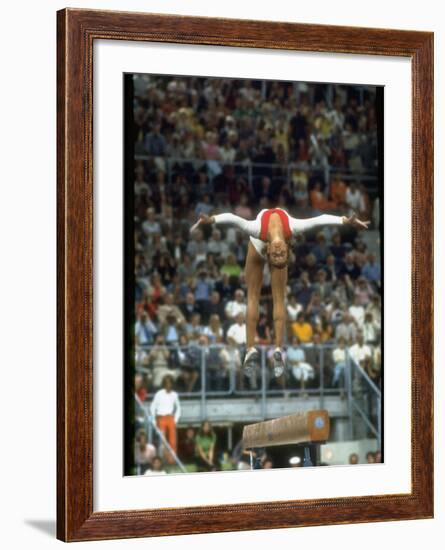 Soviet Gymnast Olga Korbut in Action on the Balance Beam at the Summer Olympics-John Dominis-Framed Premium Photographic Print