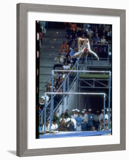 Soviet Gymnast Olga Korbut in Action on the Uneven Bars at the Summer Olympics-John Dominis-Framed Premium Photographic Print