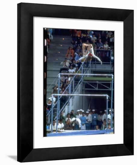 Soviet Gymnast Olga Korbut in Action on the Uneven Bars at the Summer Olympics-John Dominis-Framed Premium Photographic Print