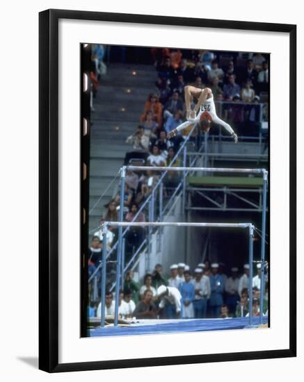 Soviet Gymnast Olga Korbut in Action on the Uneven Bars at the Summer Olympics-John Dominis-Framed Premium Photographic Print