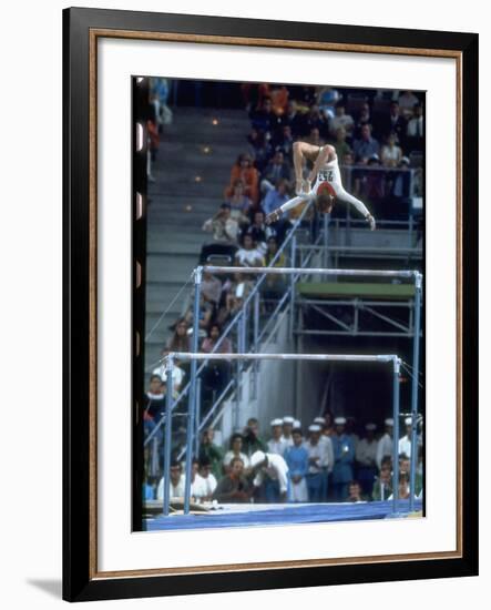 Soviet Gymnast Olga Korbut in Action on the Uneven Bars at the Summer Olympics-John Dominis-Framed Premium Photographic Print