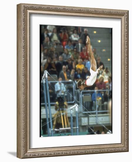 Soviet Gymnast Olga Korbut in Action on the Uneven Bars at the Summer Olympics-John Dominis-Framed Premium Photographic Print