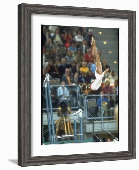 Soviet Gymnast Olga Korbut in Action on the Uneven Bars at the Summer Olympics-John Dominis-Framed Premium Photographic Print