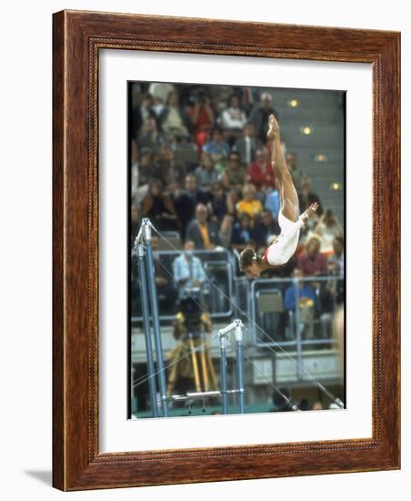 Soviet Gymnast Olga Korbut in Action on the Uneven Bars at the Summer Olympics-John Dominis-Framed Premium Photographic Print