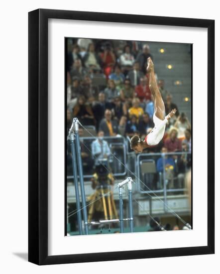 Soviet Gymnast Olga Korbut in Action on the Uneven Bars at the Summer Olympics-John Dominis-Framed Premium Photographic Print