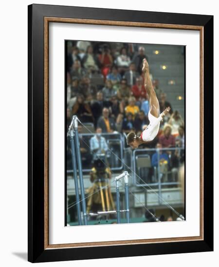 Soviet Gymnast Olga Korbut in Action on the Uneven Bars at the Summer Olympics-John Dominis-Framed Premium Photographic Print