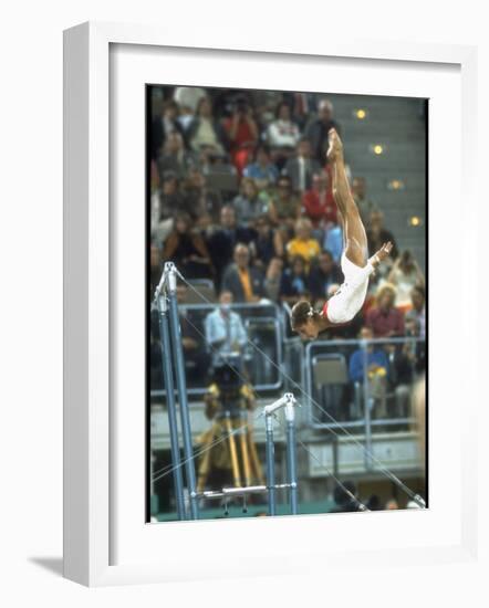 Soviet Gymnast Olga Korbut in Action on the Uneven Bars at the Summer Olympics-John Dominis-Framed Premium Photographic Print