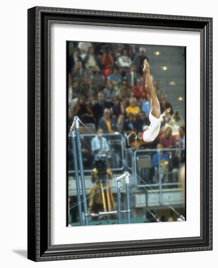 Soviet Gymnast Olga Korbut in Action on the Uneven Bars at the Summer Olympics-John Dominis-Framed Premium Photographic Print