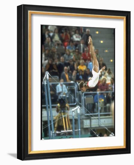 Soviet Gymnast Olga Korbut in Action on the Uneven Bars at the Summer Olympics-John Dominis-Framed Premium Photographic Print