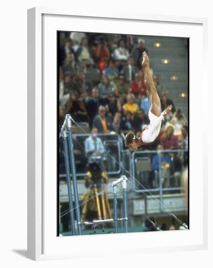 Soviet Gymnast Olga Korbut in Action on the Uneven Bars at the Summer Olympics-John Dominis-Framed Premium Photographic Print