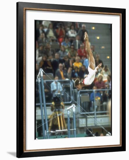 Soviet Gymnast Olga Korbut in Action on the Uneven Bars at the Summer Olympics-John Dominis-Framed Premium Photographic Print