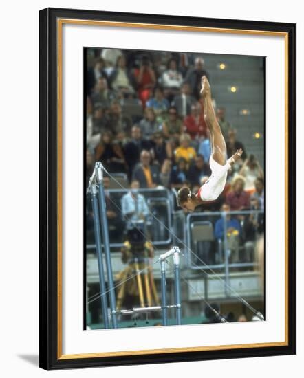 Soviet Gymnast Olga Korbut in Action on the Uneven Bars at the Summer Olympics-John Dominis-Framed Premium Photographic Print