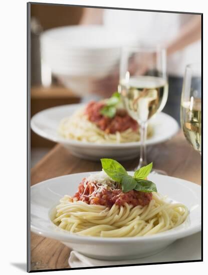 Spaghetti with Tomato Sauce and Glasses of White Wine on Table-null-Mounted Photographic Print