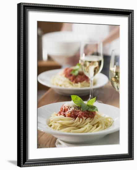 Spaghetti with Tomato Sauce and Glasses of White Wine on Table--Framed Photographic Print