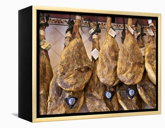 Spanish Hams Hanging in a Restaurant Bodega, Seville, Andalusia, Spain, Europe-Guy Thouvenin-Framed Premier Image Canvas