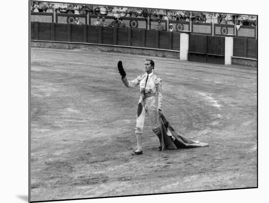 Spanish Matador Luis Miguel Dominguin Doffing His Cap as He Acknowledges the Applause of the Crown-Loomis Dean-Mounted Premium Photographic Print