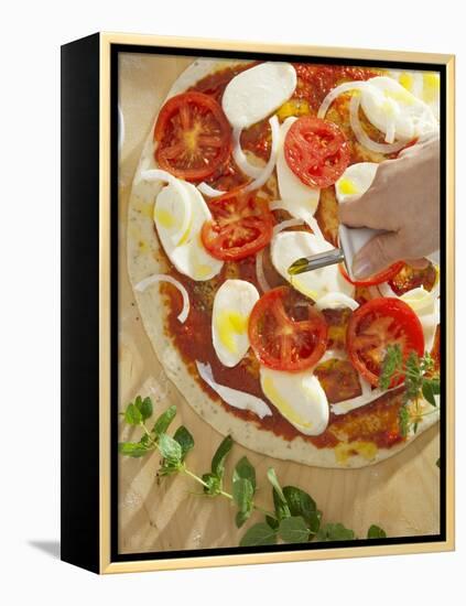 Sprinkling Pizza with Olive Oil-null-Framed Premier Image Canvas