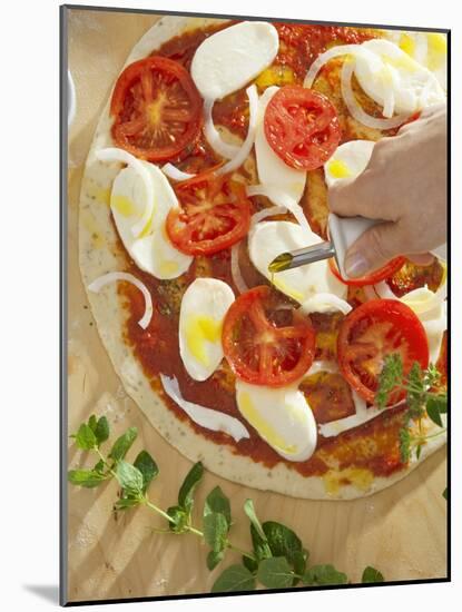 Sprinkling Pizza with Olive Oil-null-Mounted Photographic Print