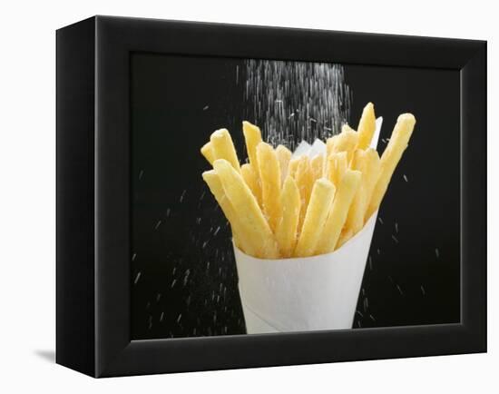 Sprinkling Salt over Chips-null-Framed Premier Image Canvas