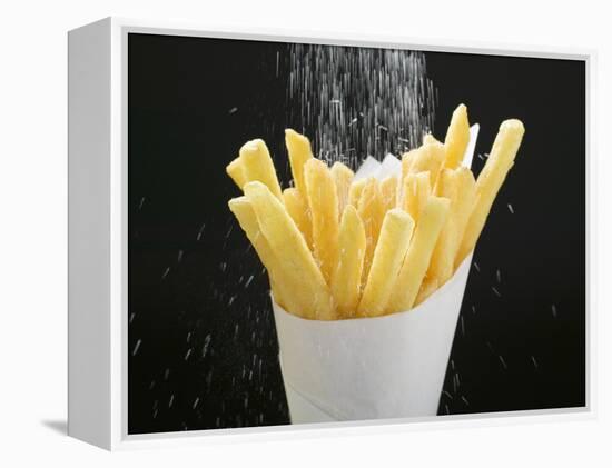 Sprinkling Salt over Chips-null-Framed Premier Image Canvas