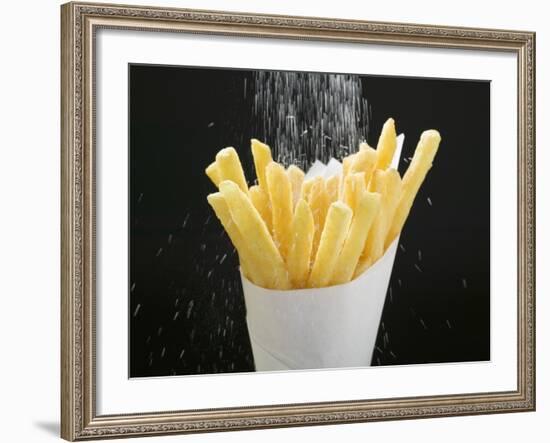 Sprinkling Salt over Chips-null-Framed Photographic Print