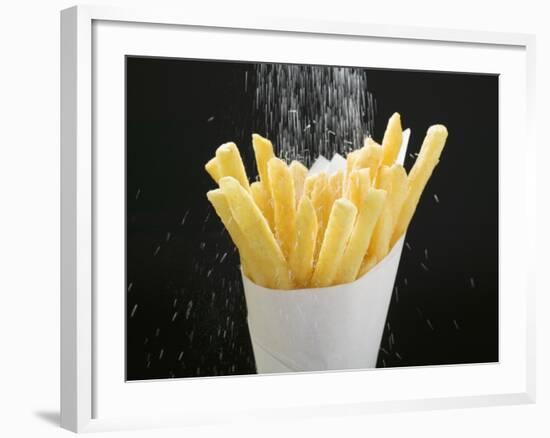 Sprinkling Salt over Chips-null-Framed Photographic Print