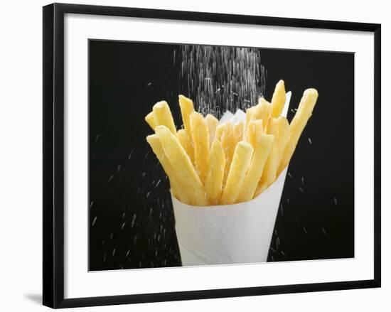 Sprinkling Salt over Chips-null-Framed Photographic Print