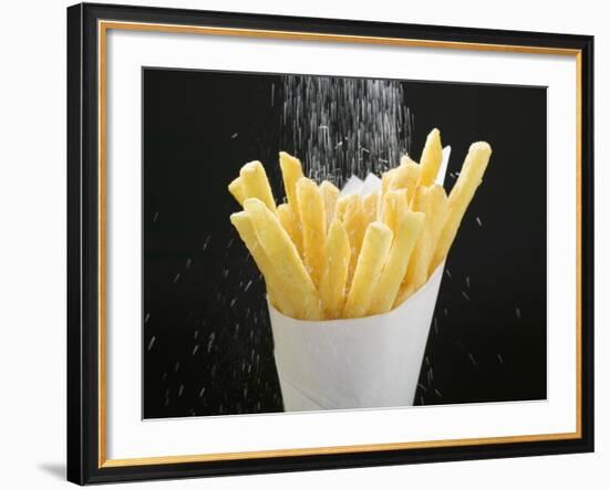 Sprinkling Salt over Chips-null-Framed Photographic Print