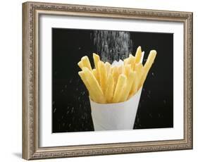 Sprinkling Salt over Chips-null-Framed Photographic Print